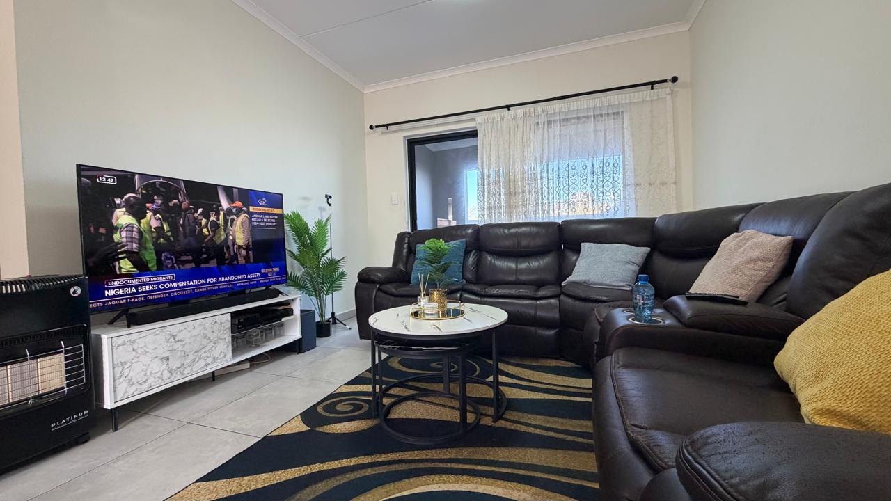Living — Open-plan lounge flowing to the patio