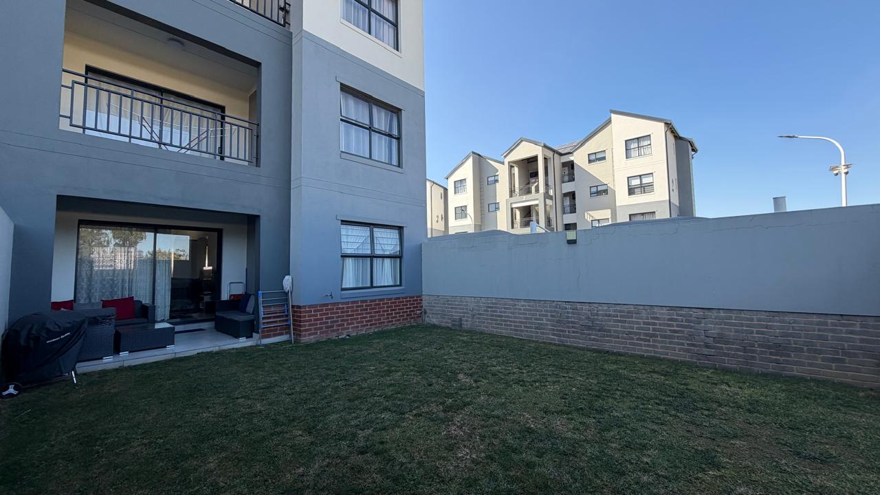 Private Garden — Walled lawn with braai space at ground level